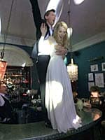 Image of a bride & groom dancing on a bar