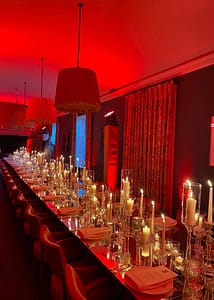 Red themed dinner party with a mirror table top