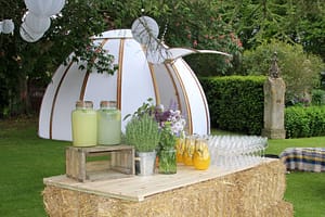 A beautiful garden with chill out dome, lighting and beautiful drinks ready for a drinks reception.