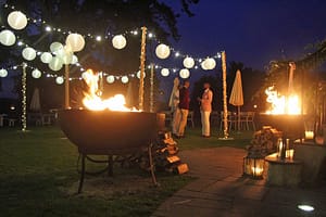 lighting canopy with festoon lighting, fairy-lighting with fire-pits close by.