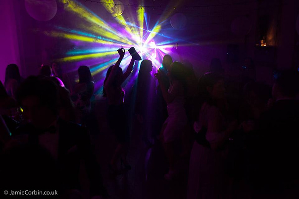 Image of a dark ballroom with dj lighting