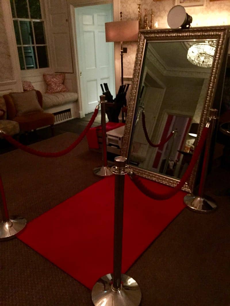 magic mirror photo booth with red carpet ropes and poles 