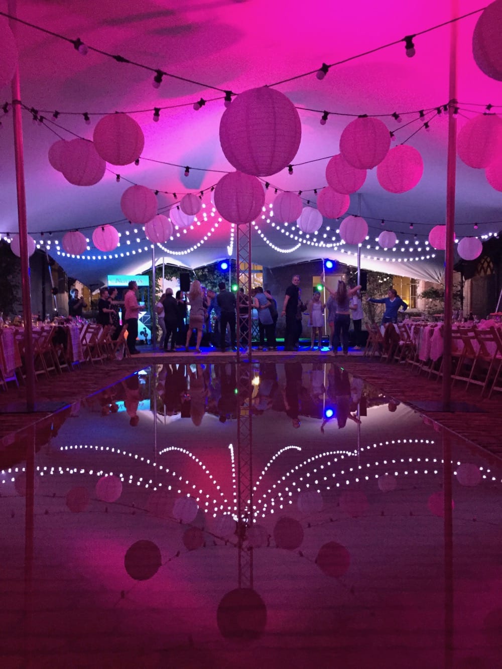 Image of stretch marquee with festoon lighting and shades.