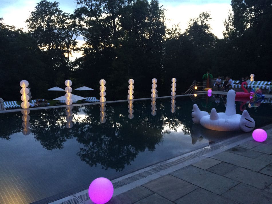 Swimming pool with LED lighting balls and large inflatable birds.