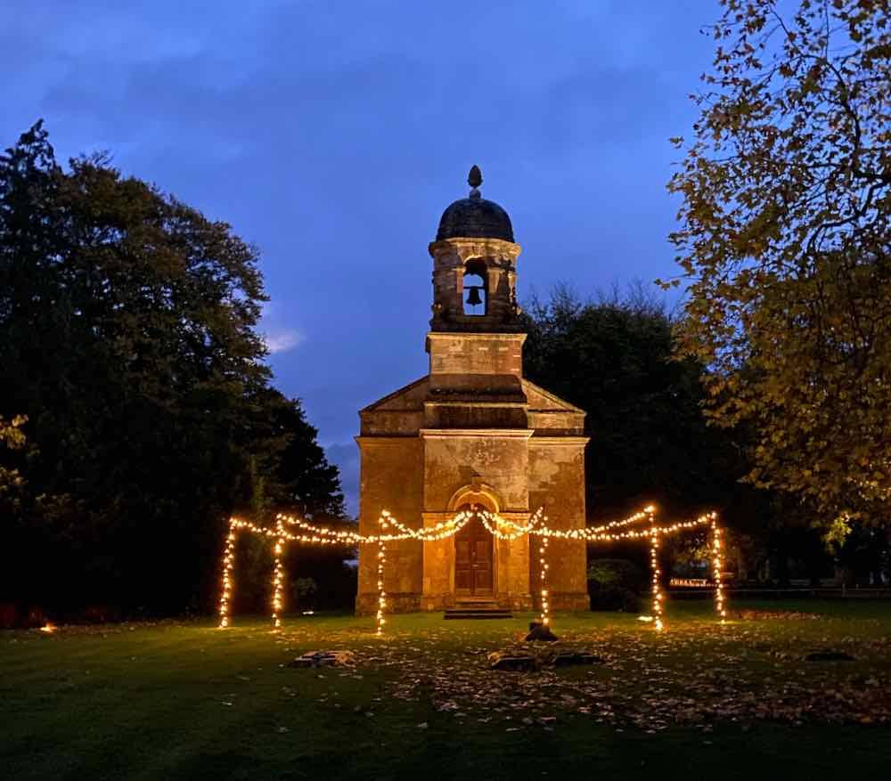 Church-fan-shaped-fairy-light-canopy-at-Babington-House Church wedding ligthing in a fan shape from the main entrance